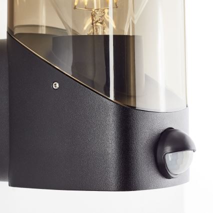 Brilliant - Outdoor-Wandleuchte mit Sensor MINOU 1xE27/10W/230V IP44 schwarz/rauchig